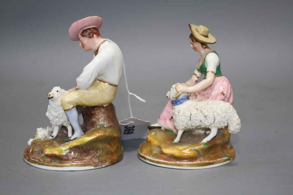 A pair of Staffordshire porcelain groups of a shepherd and shepherdess, c.1830-50, H. 11.5 -12.5cm